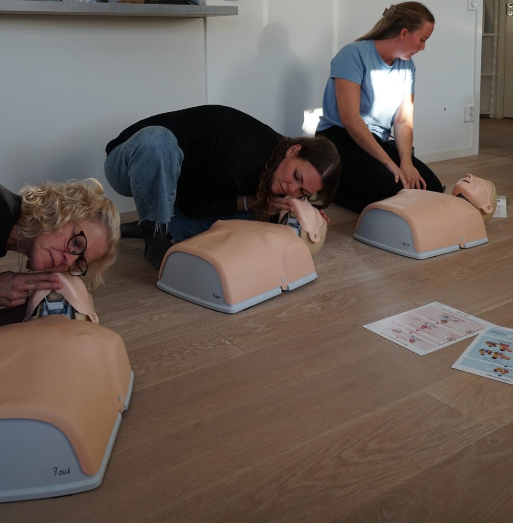 HLR-utbildning för företag med instruktör som visar hjärt-lungräddning